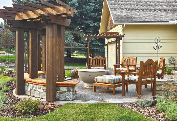 Wide view of a circular pergola patio with seating area, finished landscape design for a Bigfork residential project by Beargrass Landscape Architecture