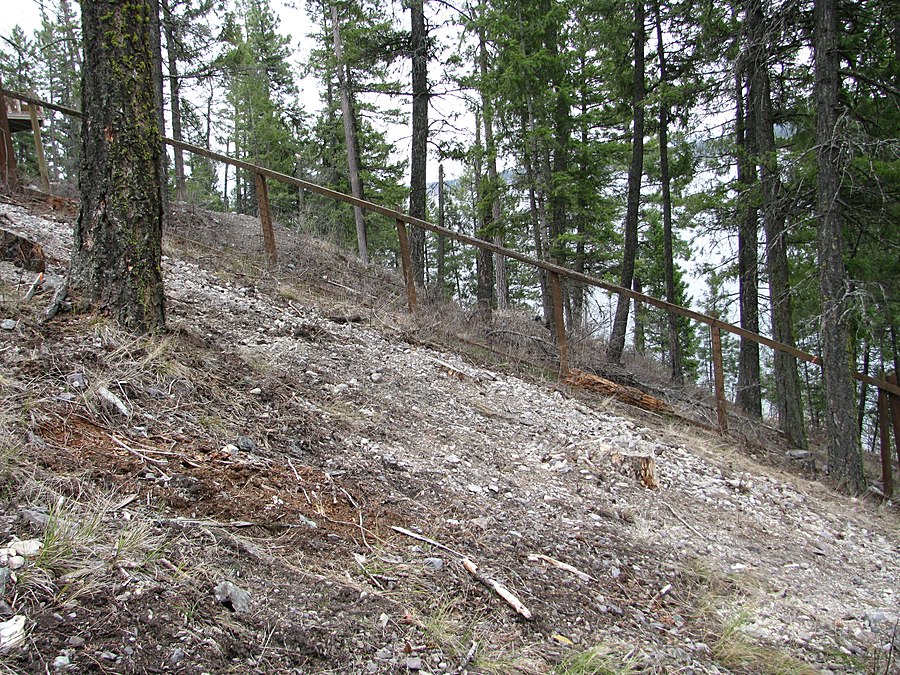 Disturbed hillside with exposed rock and soil during site excavation