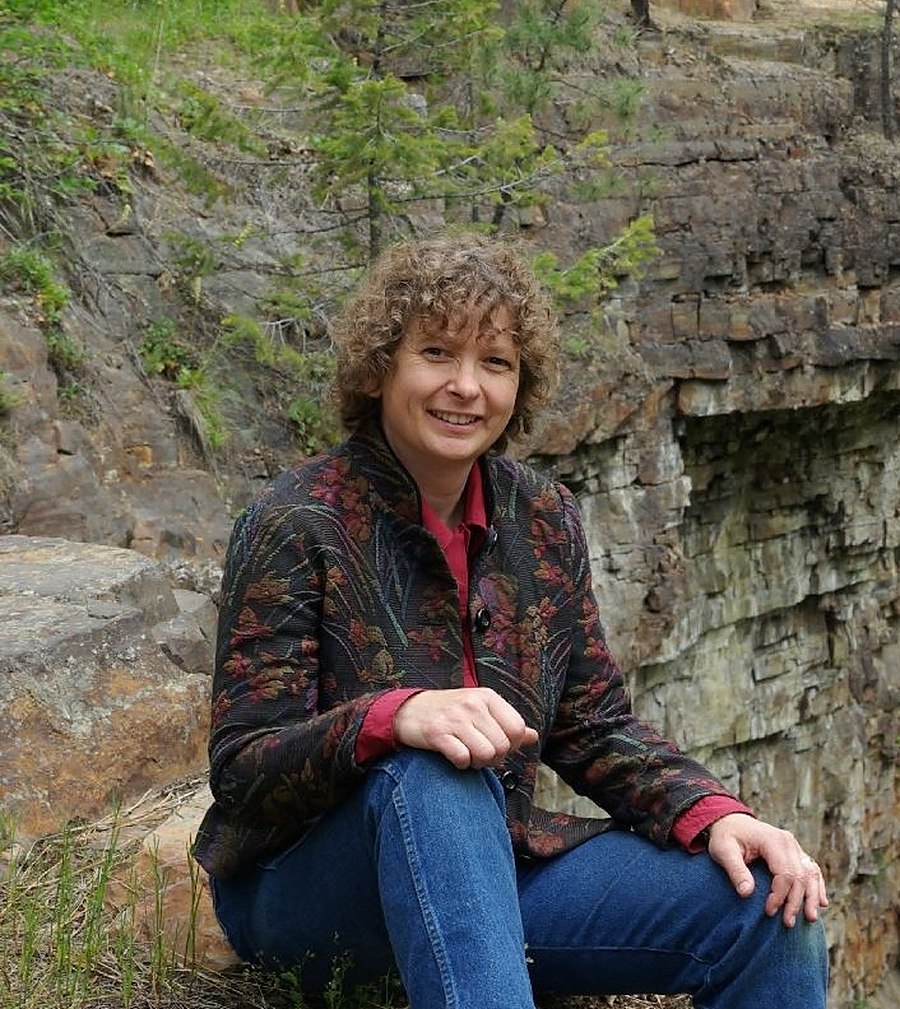 Leslie Lowe seated by a waterfall